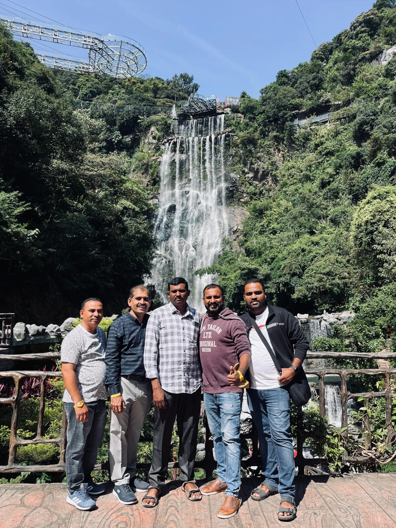 A group enjoying a visit near a waterfall